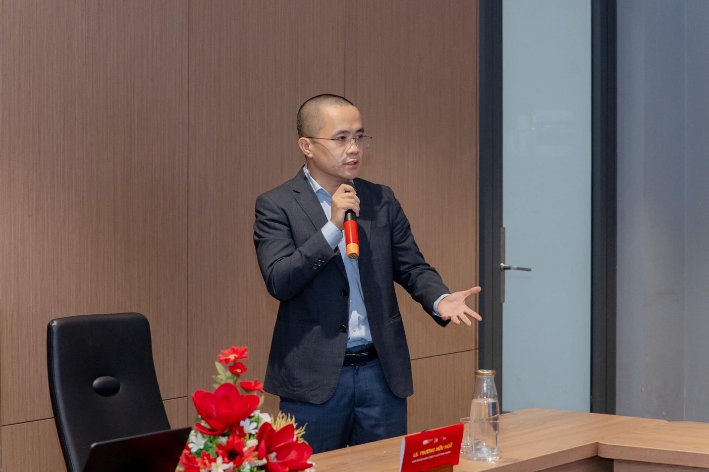 A person in a suit holding a microphone

AI-generated content may be incorrect.